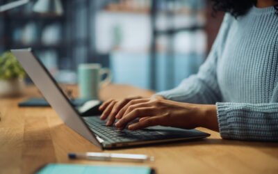 Close Up on Hands of a Female Specialist Working on Laptop